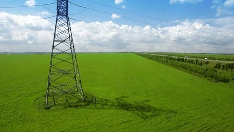 AERIAL High-voltage tower summer light sky background green grass up lift fly Stock Footage 78677942