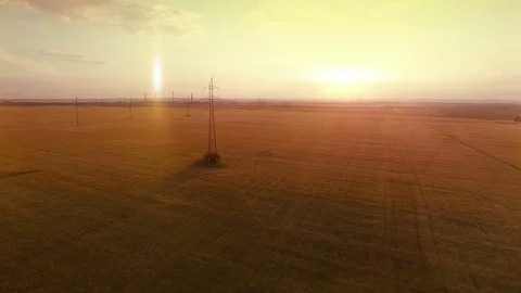 AERIAL High-voltage tower summer warm evening light camera fly near electricity Stock Footage 79852802