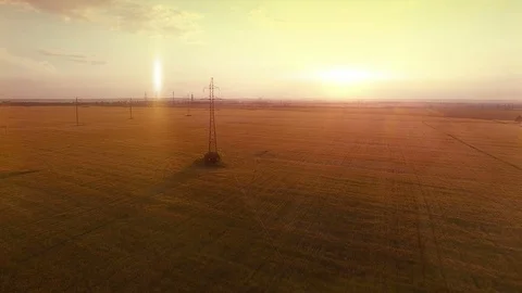 AERIAL High-voltage tower summer warm evening light camera fly near electricity Stock Footage 79852937