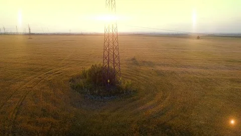 AERIAL High-voltage tower summer warm evening light camera fly up near metal Stock Footage 79853829
