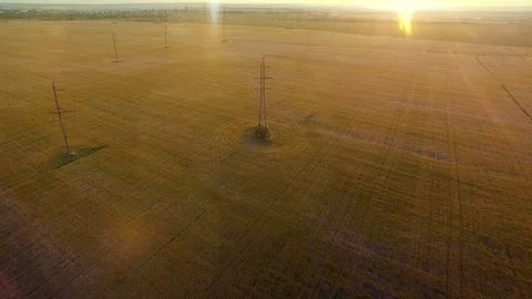 AERIAL High-voltage tower summer warm evening light camera fly over electricity Stock Footage 79855343