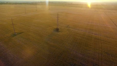 AERIAL High-voltage tower summer warm evening light camera fly over electricity Stock Footage 79855525