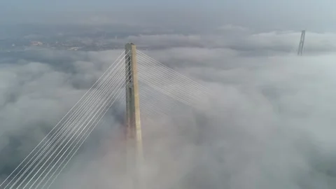 Aerial higher than clouds epic Russian bridge foggy Vladivostok epic cityscape   Stock Footage 145297762