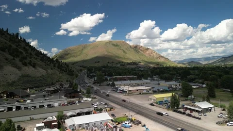 Aerial of Highway 191 through mountain town of Jackson Wyoming in Tetons Stock Footage 312911161