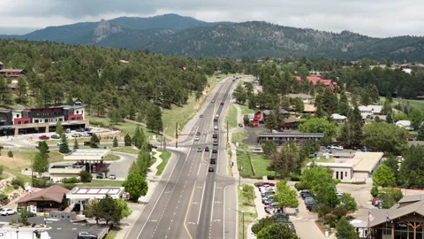 Aerial of highway 36 through small town Estes Park Colorado sunny summer day 動画素材 337138874