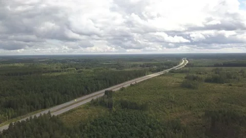 Aerial of highway E4 going Through Lush Forest and reaching to Horizon Vídeo Stock 135928415