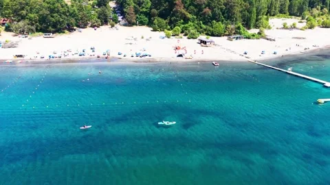 Aerial Horizontal Backward Tilting Up View of People Paddleboarding on Clea.. Stock Footage 339252253