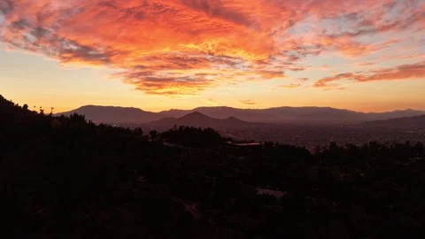 Aerial horizontal hyperlapse of a dramatic orange and red sunset over Santi.. Stock Footage 339252167