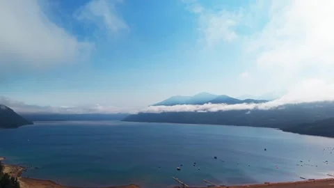 Aerial Horizontal Panning View of a Large Blue Lake and Forested Mountains .. Vídeos de archivo 339252241