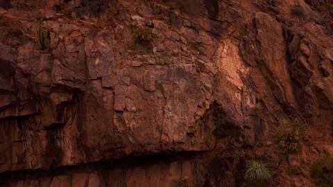 Aerial Horizontal Tracking View Climbing a Steep Arid Mountain Cliff with A.. Vídeos de archivo 339254166