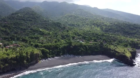 Aerial hover over black sand beach Stock Footage 329320599