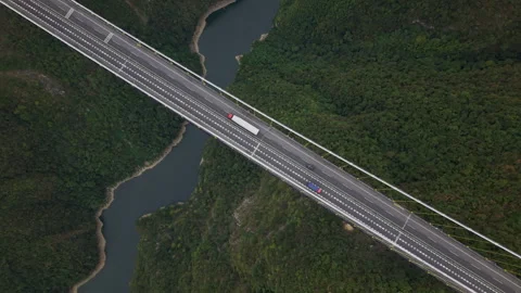 Aerial Hover Over Highway Suspension Bridge Across Valley 4K HLG Stock Footage 345620890