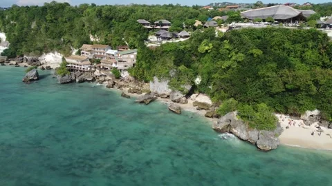 Aerial hover over left cliffs Padang Padang Stock Footage 329139177