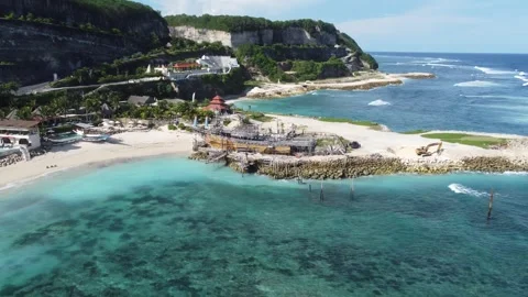 Aerial hover to pan right with ship at Melasti Stock Footage 329135034