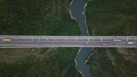 Aerial Hover Scenic Suspension Bridge Valley Traffic 4K HLG Stock Footage 345620794