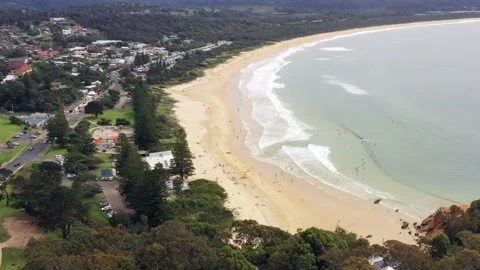 Aerial hovering over Tathra beach in town on Sapphire coast with wharf as 4k. Stock Footage 195296333