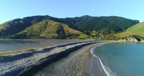 Aerial hovering view of natural boulder causeway,Nelson,Cable Bay, New Zealand Stock Footage 140624123