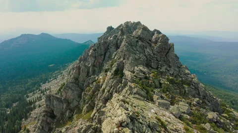 Aerial: huge mountain range with steep cliff slopes, bare rocks, panoramic view Stock Footage 137795886