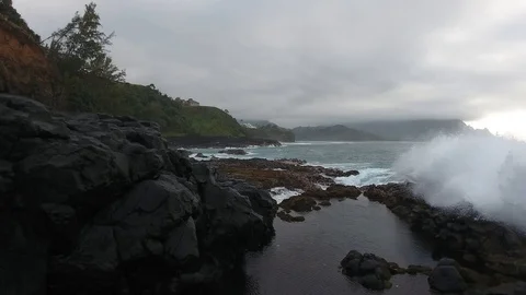 Aerial of huge rough waves at queens bath kauai hawaii in 4k Stock Footage 88936467