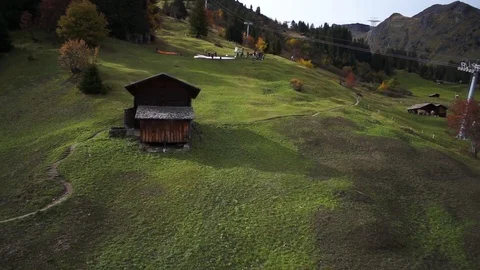 Aerial of huts and cattle on rolling landscape Stock Footage 76005940