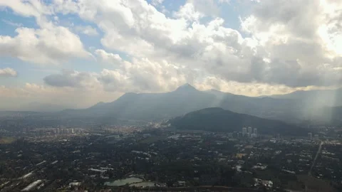 Aerial hyper lapse of clouds just after rain with sun-rays hitting the city Vidéo 136011927