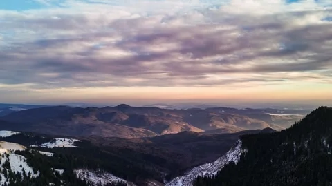 Aerial hyper lapse of clouds moving above mountains Stock Footage 274780126