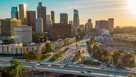 Aerial hyper lapse of downtown Los Angeles skyline and freeway traffic Stock Footage 99012402