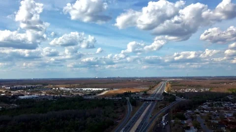 An aerial hyper lapse of Florida's Turnpike on a sunny day with clouds casting Stock Footage 332072136