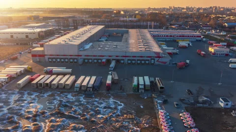 Aerial hyper lapse (hyperlapse) of a logistics park with a warehouse and trucks Stock Footage 150313212