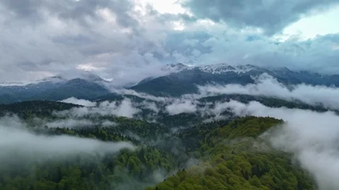 Aerial hyper lapse of mountain landscape with fog moving above green forest Stock Footage 308962500