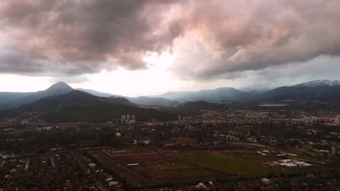 Aerial Hyper lapse of pink clouds above the mountains and city Stock-Footage 136011976