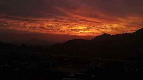 Aerial hyper-lapse of the sunset flying horizontally above the city Stock Footage 135495419