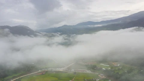 Aerial Hyper lapse Time lapse. Over mountains and covered with dense ground fog  Stock Footage 141523145