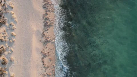 Aerial Hyper lapse of top down view of empty sandy beach and blue water and f Stock-Footage 152542618