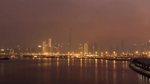 Aerial hyper-lapse view of Burj Khalifa skyscraper and Dubai skyline at night Stock Footage 198563585