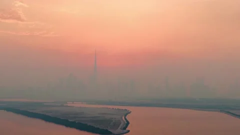 Aerial hyper lapse view of Burj Khalifa skyscraper and Dubai skyline at sunset Stock Footage 198563600