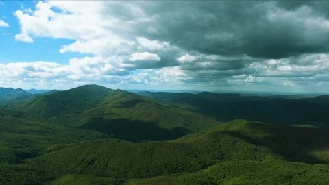 Aerial hyperlaps timelapse of misty clouds on tree covered mountains. Video stock 97530685