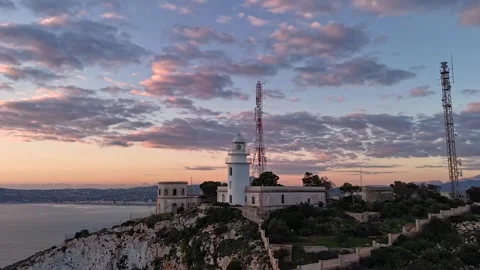Aerial Hyperlapse 4K - Cabo de la Nao Lighthouse at Dusk, Javea Spain 動画素材 335551174