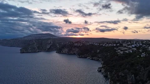 Aerial Hyperlapse 4K - Cala Ambolo Cliffs Sunset to Dusk, Javea Spain 動画素材 335566322