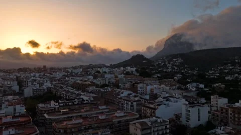 Aerial Hyperlapse 4K - Storm Over Javea Town Rooftops at Sunset, Spain 動画素材 335549727