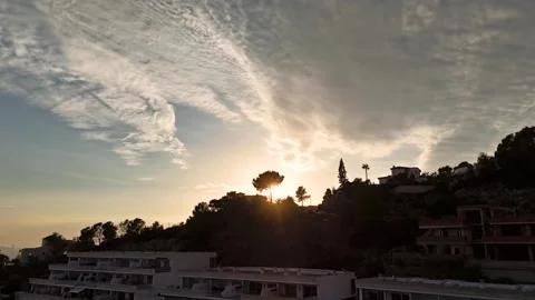 Aerial Hyperlapse 4K - Sunset Behind Pine Tree Silhouette, Altea Hills 動画素材 335551015