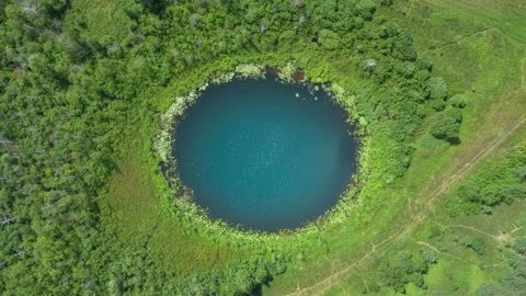 Aerial hyperlapse amazing round shape lake, sky reflected in clear water Stock Footage 136306536