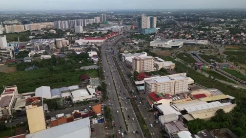 Aerial hyperlapse of busy highway traffic in downtown Iloilo City, Philippines Stock Footage 333513430
