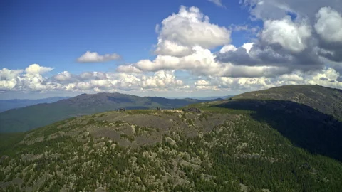 Aerial hyperlapse of clouds over a mountain range in the Kuturchinsky Belogorie 動画素材 169300975