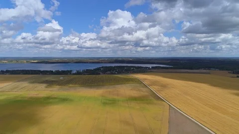 Aerial hyperlapse of clouds passing over a field. Shadows and sun alternating Stock Footage 93665279