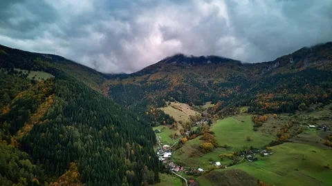 Aerial hyperlapse of cloudy mountain valley with autumn forest and moody Video stock 321074943