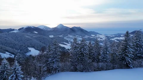 Aerial hyperlapse of dramatic clouds moving over winter mountain peaks and snowy Видео 336394695