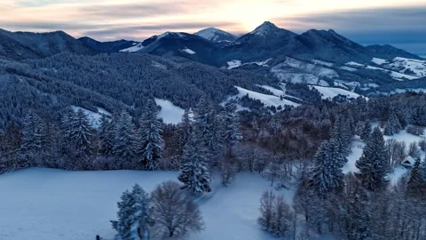 Aerial hyperlapse of dramatic clouds moving over winter mountain peaks and snowy Stock Footage 336394780