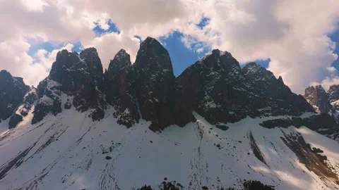 Aerial hyperlapse of fast moving clouds over Odle mountain peaks in Video stock 338433303