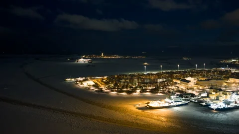 Aerial hyperlapse of ferries in front of Katajanokka, winter night in Helsinki Stock Footage 331422561